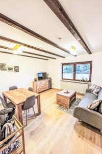 a living room with a couch and a table at Holiday Home Am Hohen Bogen-44 by Interhome in Arrach