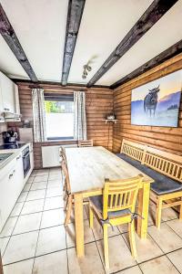 a kitchen with a table and chairs in a room at Holiday Home Am Hohen Bogen-44 by Interhome in Arrach
