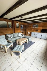 a living room with a couch and a table at Holiday Home Am Hohen Bogen-44 by Interhome in Arrach +29 photos