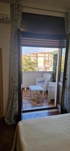 a view of a bedroom with a view of a patio at A Casa Di Luca in Diamante