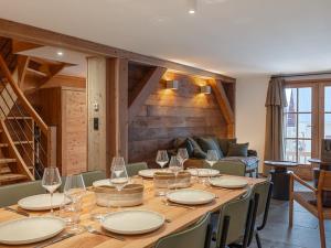 a dining room with a table with wine glasses at Maison rénovée familiale au village - FR-1-808-19 in Le Monêtier-les-Bains