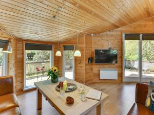 ein Wohnzimmer mit Tisch und Fernseher in der Unterkunft Holiday Home Jorina - 700m to the fjord by Interhome in Ringkøbing