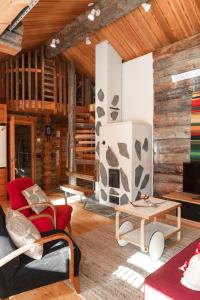 a living room with wooden walls and a fireplace at Villa Talvikolo - Spacious 2BR Cabin with Sauna in Ruka +28 photos