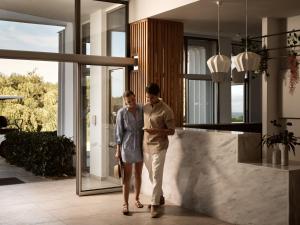 two men walking down a hallway in a house at Hotel St.John Suites Adults Only in Tsilivi +80 photos