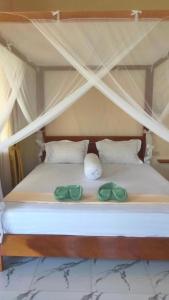 Postel nebo postele na pokoji v ubytování Leuser Inn & Jungle Trekking