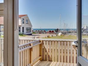 a balcony with a view of the ocean at Holiday Home Ljubinko - 50m from the sea by Interhome in Læsø +7 photos