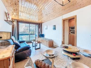 a living room with a couch and a table at Apartment Pegase Phenix-74 by Interhome in Le Corbier +29 photos