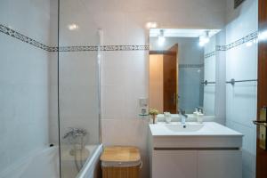 a white bathroom with a sink and a shower at Apartamento Brava JT in Ribeira Brava +24 photos