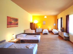 a living room with several beds and a couch at Studio Ysella by Interhome in Raiding