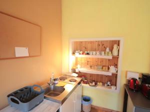 a kitchen with a sink and a counter with a shelf at Studio Ysella by Interhome in Raiding