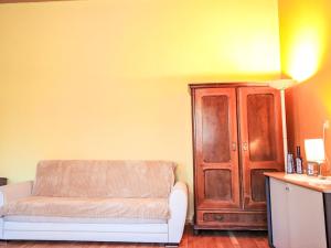 a living room with a couch and a wooden cabinet at Studio Ysella by Interhome in Raiding