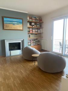 a living room with two circular tables and a fireplace at Top Lake View in Faggeto Lario 