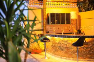 a bar with two stools in front of a counter at Hamed's House Luxor in Luxor