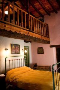 ein Schlafzimmer mit einem Bett mit gelber Tagesdecke in der Unterkunft Ferienhaus für 2 Personen  2 Kinder ca 50 qm in Alajar, Andalusien Provinz Huelva in Alájar