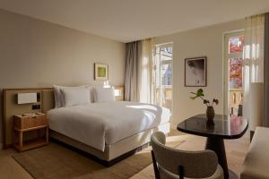 a hotel room with a bed and a table at The Florentin by Althoff Collection in Frankfurt/Main +46 photos