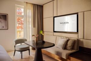 a living room with a couch and a table at The Florentin by Althoff Collection in Frankfurt/Main