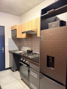 a kitchen with a stainless steel stove top oven at Sunset Sucasa in Midrand