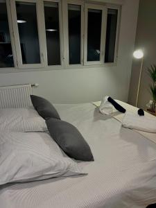 a large white bed with pillows on top of it at Charmant studio in Villeurbanne