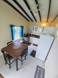 a kitchen with a table and chairs and a whiteboard at Ocean Heights in Arnos Vale