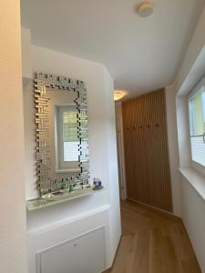 a bathroom with a mirror on the wall at Appartement Silbermond in Schladming