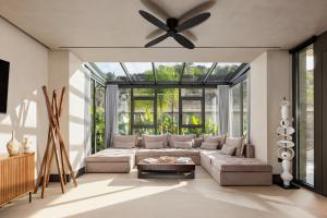 a living room with a couch and a ceiling fan at Omega Residences in Karpathos