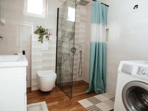 a bathroom with a shower with a toilet and a sink at Villa Lotta & Nolla in Mostar