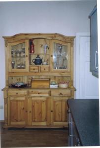 黑灵斯多夫Ferienwohnung In Gründerzeitvilla In Strandnähe的厨房里一个木制橱柜，上面放着餐具。 更多1张照片