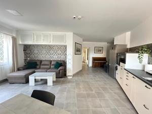a kitchen and living room with a couch and a table at Sweet Home Fleming in Rome