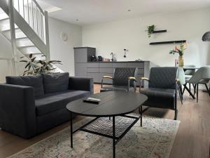 a living room with a couch and a table at Tante Ursula B&B in Venlo