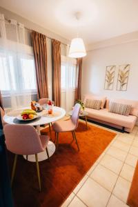 a living room with a table and chairs and a couch at Αγροικία Mυλόδεση in Kalavrita