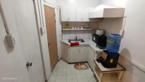 a small kitchen with a sink and a plate of food at Kochimoto Guestroom in Baguio