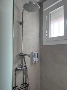 a shower with a shower head in a bathroom at Mercedes Park in Montilla +19 photos