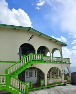 a building with a green staircase on it at Ocean Heights in Arnos Vale