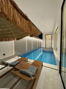 a swimming pool with a chaise lounge next to a building at شاليهات روح الخبر in Al Khobar