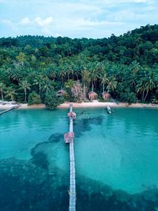 an aerial view of a pier in the water next to a beach at Poki Poki - Togian Islands in Bomba