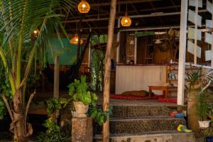 a building with stairs and plants and lights at Poki Poki - Togian Islands in Bomba
