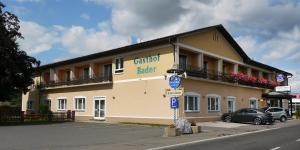 a building with a car parked in front of it at Gasthof Bader in Deutsch Goritz