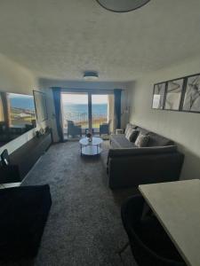 a living room with a couch and a table at View of the Isles in Largs