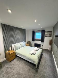 a bedroom with a large bed and a window at View of the Isles in Largs