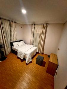 Ένα ή περισσότερα κρεβάτια σε δωμάτιο στο Canaan Apartment