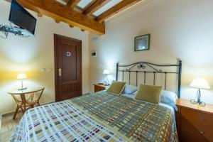 a bedroom with a large bed and a table at Posada La Canal in Ubiarco