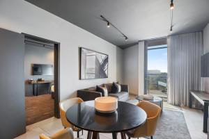 a living room with a table and a couch at The Capital Boardwalk in Gqeberha
