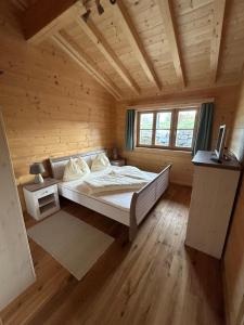 a bedroom with a bed in a wooden room at Chalet - Appartementhaus Alma in Haus im Ennstal +98 photos