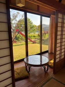 a room with a table and a view of a playground at Farm Stay Umemura - Vacation STAY 21213v in Imari +11 photos