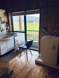 a kitchen with a chair and a washing machine at Farm Stay Umemura - Vacation STAY 21213v in Imari