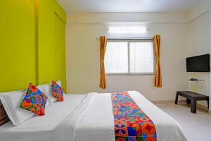 Ένα ή περισσότερα κρεβάτια σε δωμάτιο στο Via Arrow Residency