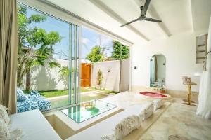 an open living room with a large window at Sole 1BR Romantic Villa, 5 Min to Thomas Beach in Badung