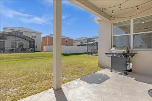 a barbecue grill outside of a house at 5 Bedrooms 5 Bathrooms Crystal Cove 1042Td in Kissimmee