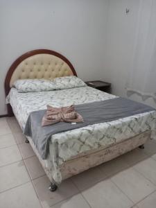 a bed with a pair of shoes sitting on it at Casa de Praia - Praia Bela in Aquiraz +65 photos