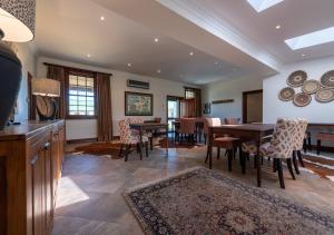 a kitchen and dining room with a table and chairs at Trumpetters Drift Private Wildlife Lodge in Grahamstown